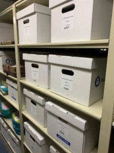 Photo of white Up with People archive boxes stacked on shelves