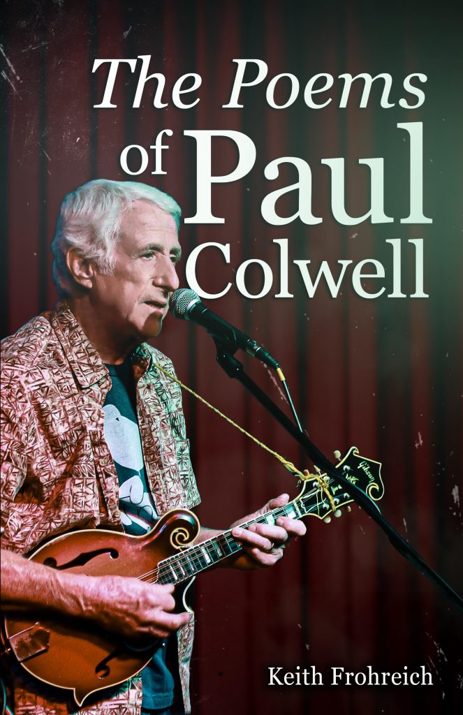 Photo of the book cover The Poems of Paul Colwell featuring Paul playing a guitar in front of a red curtain.