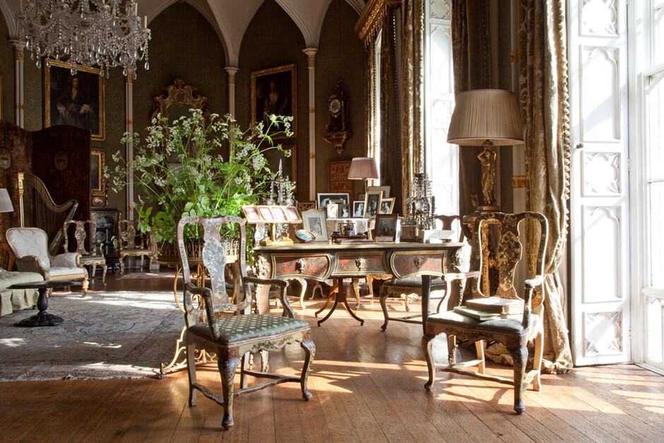 An ornate room with very high ceilings and antique furniture